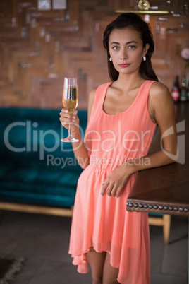 Portrait of confident woman holding a champagne flute