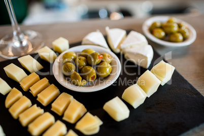 Cheese slices and olives on tray
