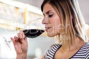 Young woman drinking wine at restaurant