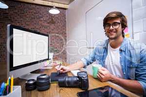 Portrait of smiling graphic designer working in office