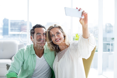 Couple taking selfie on couch