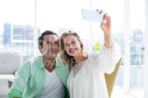 Couple taking selfie on couch