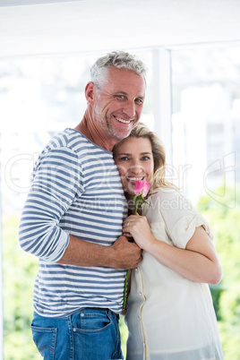 Portrait of romantic mature couple with pink rose