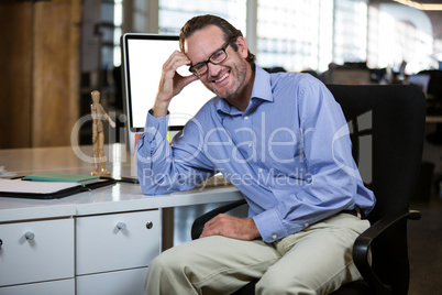 Creative businessman leaning at computer desk