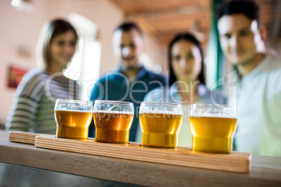 Friends in front of beer sampler