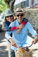 Mature couple hugging while riding bicycle