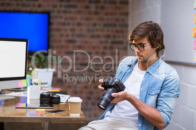 Man holding camera in office