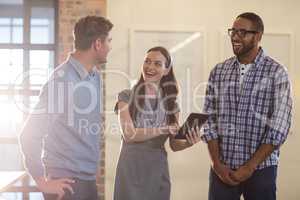 Happy colleagues discussing in office