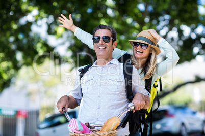 Cheerful couple riding bicycle
