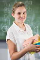 Portrait of smiling school teacher in classroom