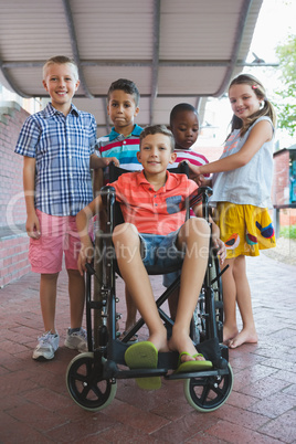 Portrait of smiling schoolkids in corridor