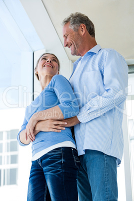 Low angle view of mature couple embracing