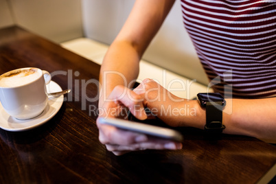 Midsection of woman using smartphone