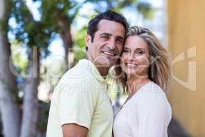 Happy couple standing on street