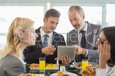 Business people having meal in restaurant