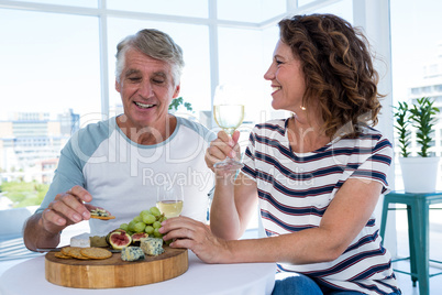 Happy mature couple sitting at restaurant