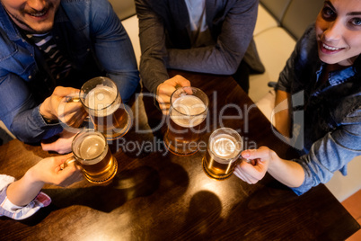 Friends toasting beer at restaurant