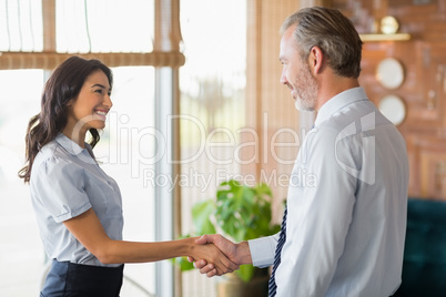 Man and woman shaking hands at meeting