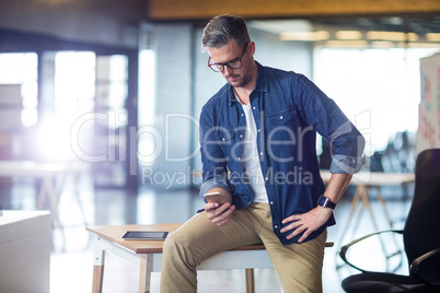 Man using mobile phone in office