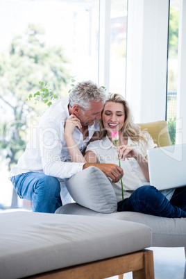 Romantic smiling mature couple with rose