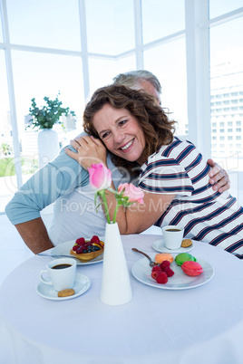 Smiling woman hugging man