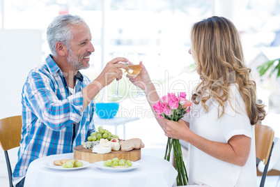 Mature couple toasting wineglass in restaurant