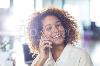 Portrait of smiling woman talking on phone