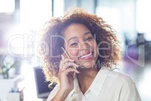 Portrait of smiling woman talking on phone