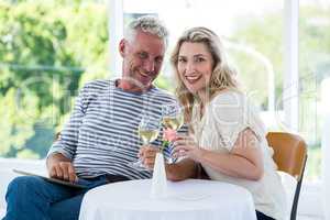 Portrait of smiling mature couple holding wine glasses