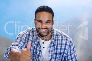 Businessman gesturing thumbs up in office