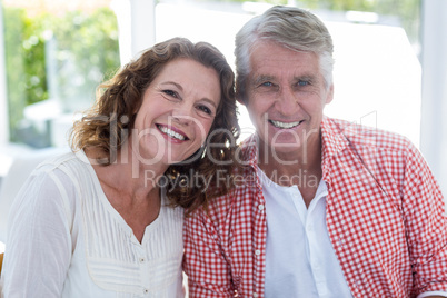 Smiling mature couple in restaurant