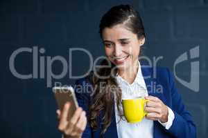 Happy woman taking selfie in office