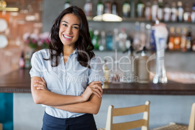 Portrait of smiling woman standing with arms crossed Portrait of smiling woman standing with arms crossed