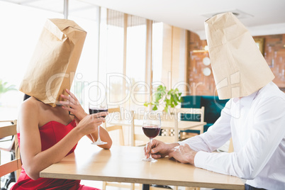 Couple with brown paper bags over their heads