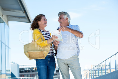 Happy couple holding map