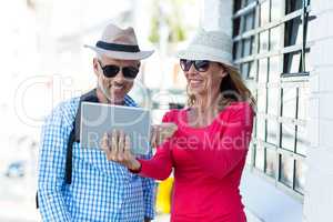 Mature couple looking in digital tablet