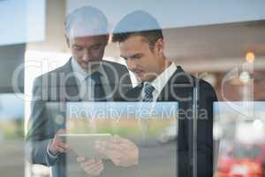 Two businessmen using digital tablet