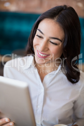 Businesswoman using digital tablet in cafÃ©