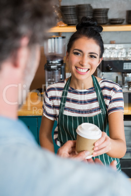 Waitress giving cup of coffee to customer