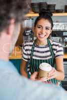 Waitress giving cup of coffee to customer