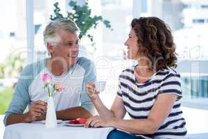 Happy couple sitting at restaurant