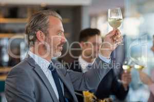 Portrait of businessman toasting his beer glass