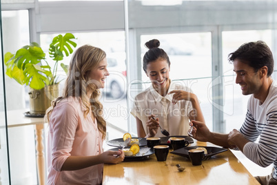 Group of happy friends having dessert together Group of happy friends having dessert together