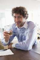 Happy man holding a glass of alcohol