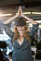 Businesswoman with hands joined using virtual reality simulator