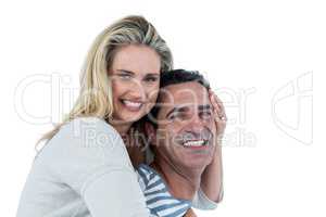 Smiling man carrying woman piggyback
