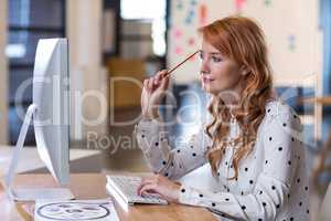 Thoughtful businesswoman sitting at desk