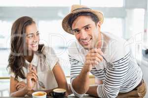 Smiling couple having dessert