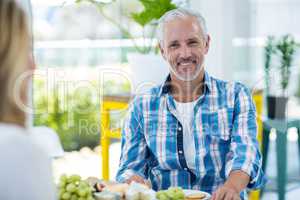 Happy man with woman at in restaurant
