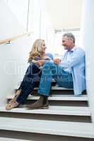 Full length of couple sitting on steps
